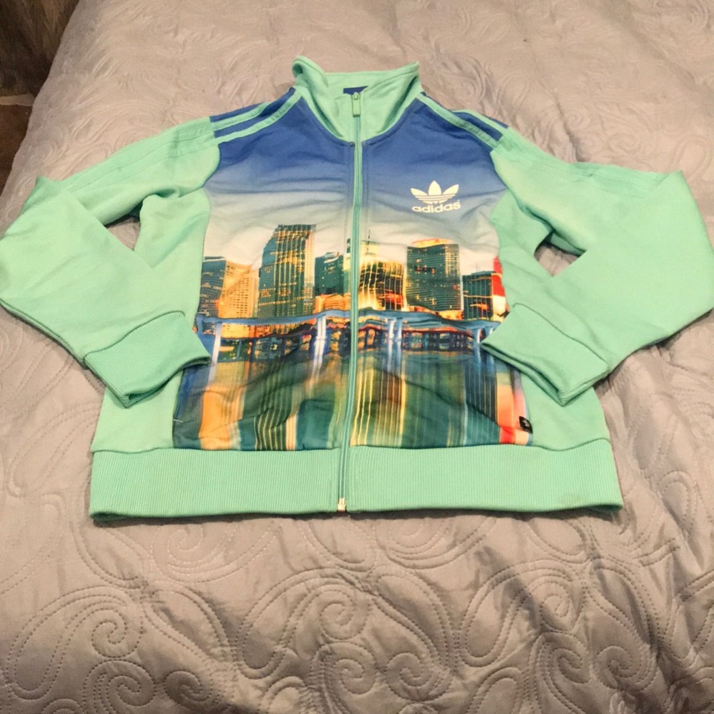Cityscape Adidas mock-neck full zip track jacket.